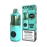 An AA-sized vape device in Miami Mint flavor next to its retail packaging box. The device features a translucent mint green upper chamber and a textured light blue lower body with a circular black and blue logo.
